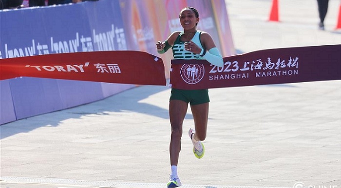 Siranesh Yirga from Ethiopia crosses the finish line at the 2023 Shanghai Marathon.